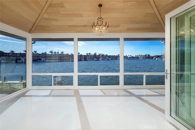 unfurnished sunroom with a chandelier, a water view, lofted ceiling, and wooden ceiling