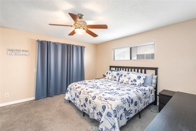 bedroom featuring ceiling fan, carpet flooring, and a textured ceiling