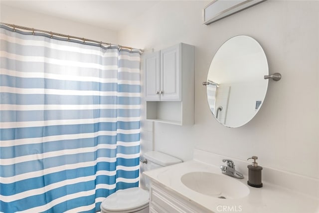 bathroom featuring vanity, a shower with curtain, and toilet