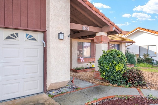 view of exterior entry with a garage