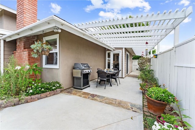 view of patio featuring a grill and a pergola