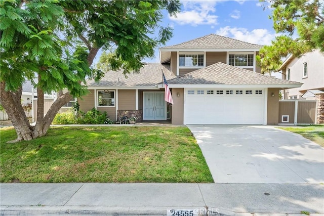 view of front facade with a garage and a front yard