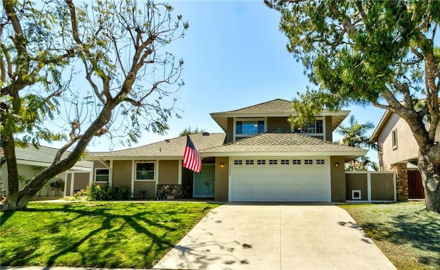 view of front of home featuring a garage and a front yard