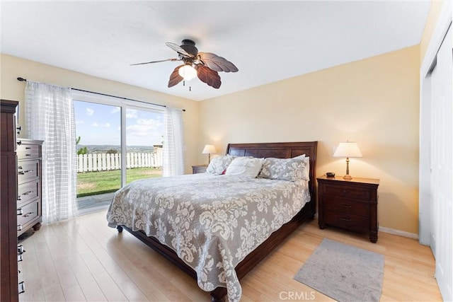 bedroom featuring access to exterior, ceiling fan, and light wood-type flooring