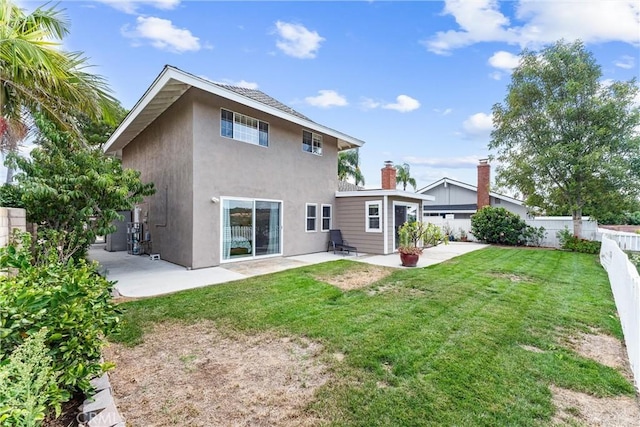 back of house featuring a yard and a patio