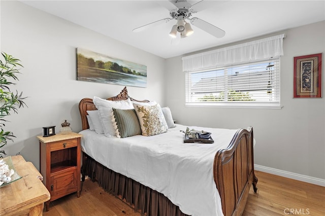 bedroom with ceiling fan and light hardwood / wood-style floors