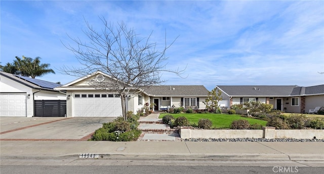 ranch-style home with a garage and a front lawn