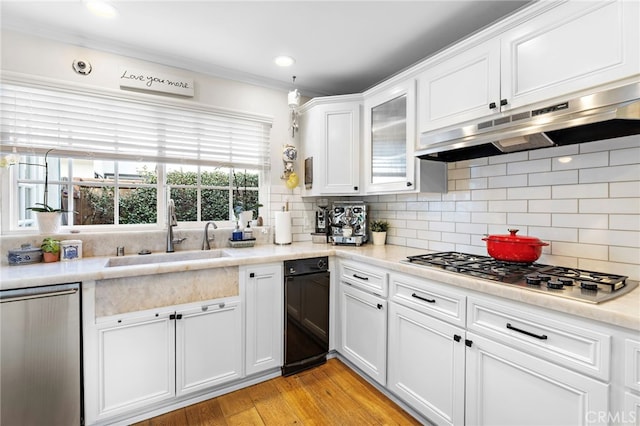 kitchen featuring white cabinetry, appliances with stainless steel finishes, sink, and tasteful backsplash