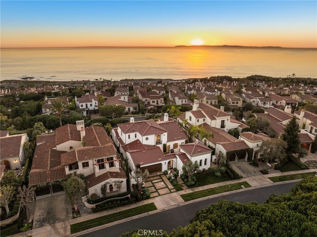 aerial view at dusk with a water view