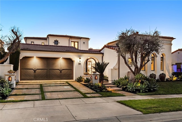 mediterranean / spanish house featuring a garage