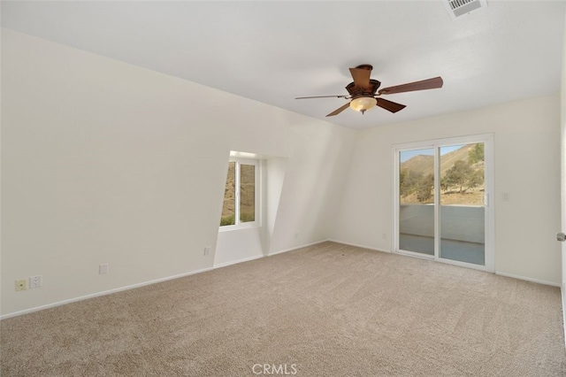 carpeted spare room with ceiling fan