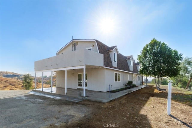 back of property featuring a patio and french doors