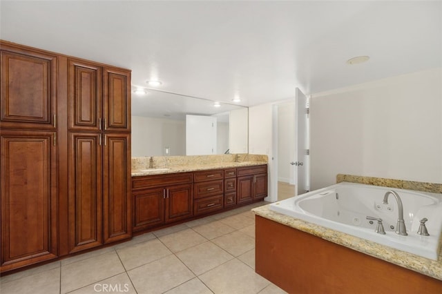 bathroom featuring tile patterned floors, vanity, and a bathtub