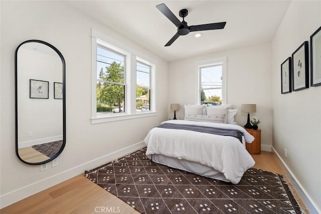 bedroom with ceiling fan and dark hardwood / wood-style flooring