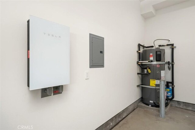 utility room featuring electric panel and water heater