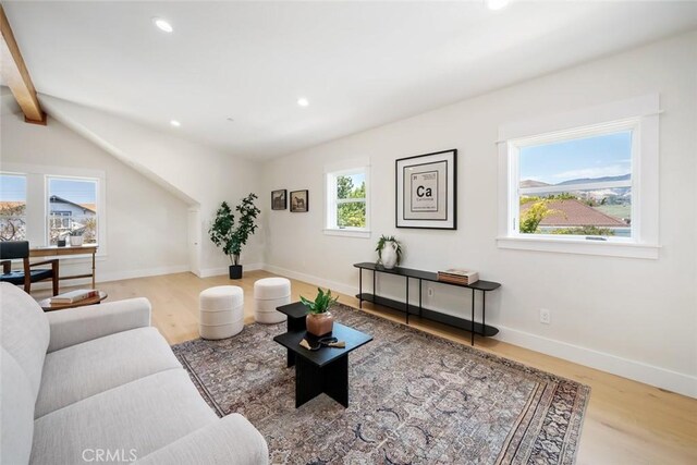 living room with beamed ceiling and wood-type flooring