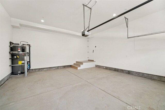 garage with a garage door opener and secured water heater