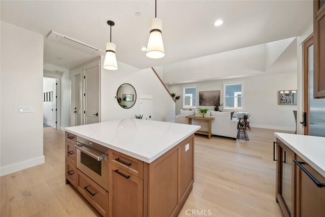 kitchen featuring pendant lighting, light hardwood / wood-style floors, and a kitchen island