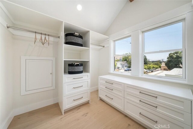 spacious closet featuring lofted ceiling and light hardwood / wood-style floors