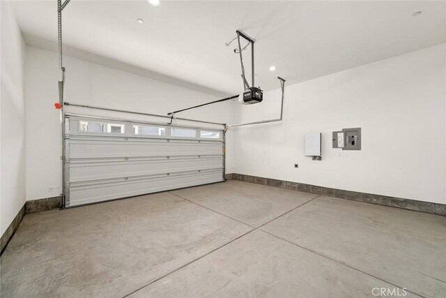 garage with a garage door opener and electric panel