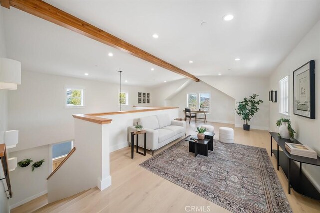 living room featuring light hardwood / wood-style flooring and beamed ceiling