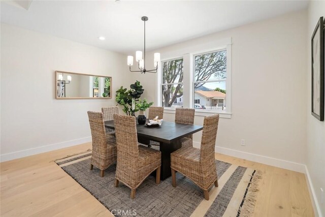 dining space featuring a chandelier and light hardwood / wood-style floors