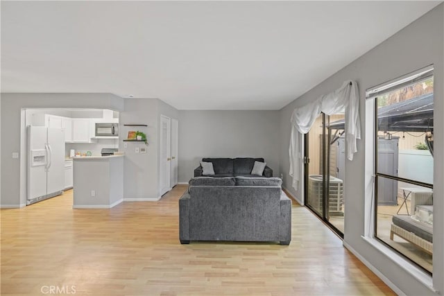 living room featuring baseboards and light wood finished floors