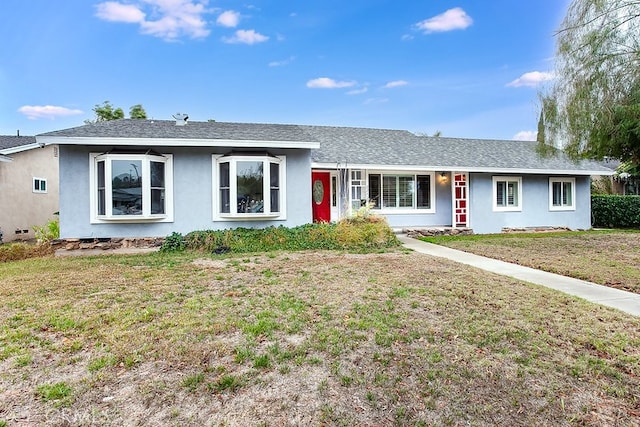 ranch-style home featuring a front yard