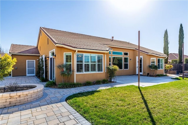 back of house featuring a yard and a patio area