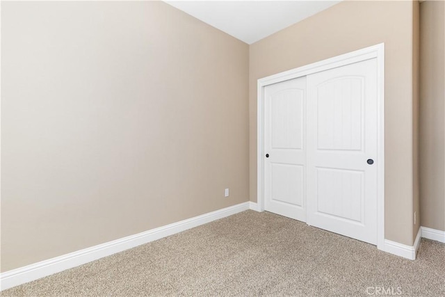 unfurnished bedroom with a closet and carpet