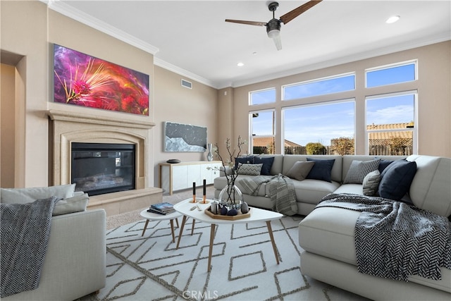 living room with crown molding and ceiling fan