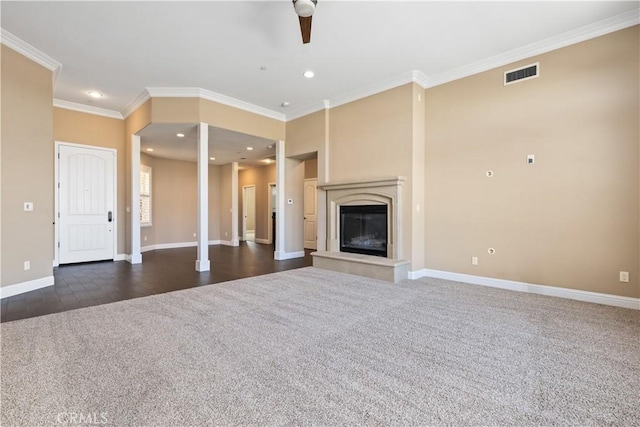 unfurnished living room with ornamental molding, ceiling fan, and dark colored carpet