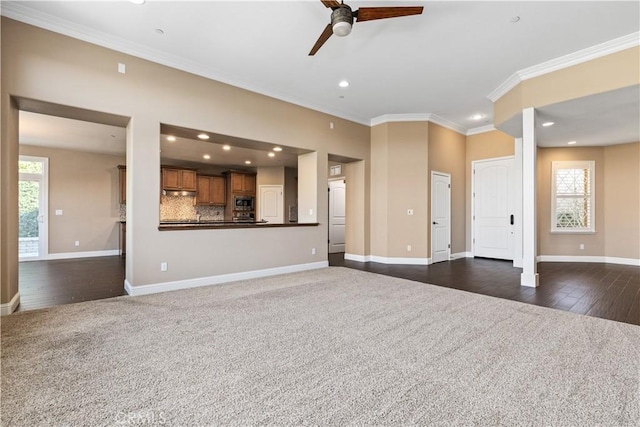 unfurnished living room featuring crown molding, ceiling fan, and dark colored carpet