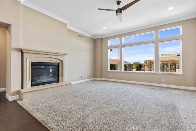 unfurnished living room featuring dark wood-type flooring, ceiling fan, ornamental molding, and a tile fireplace