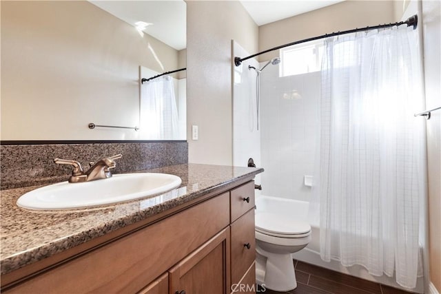 full bathroom with vanity, wood-type flooring, shower / bathtub combination with curtain, and toilet