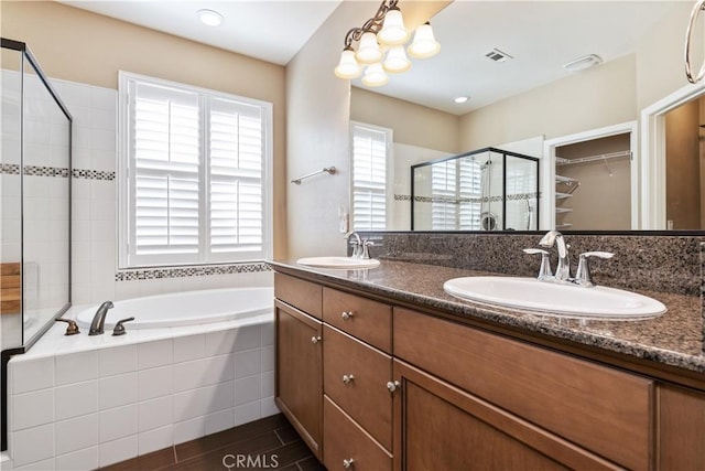 bathroom featuring vanity, separate shower and tub, and wood-type flooring