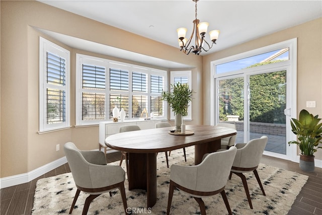 dining space featuring an inviting chandelier and dark hardwood / wood-style floors