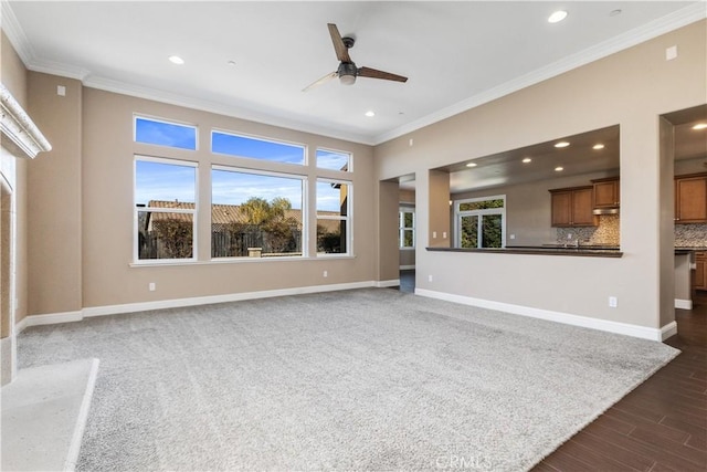 unfurnished living room with crown molding, dark hardwood / wood-style floors, and ceiling fan