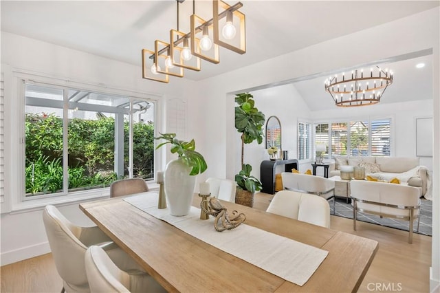 dining room featuring light hardwood / wood-style flooring and a notable chandelier