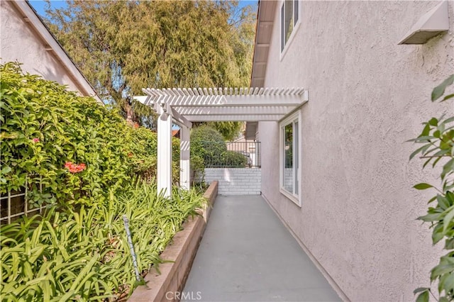 view of home's exterior featuring a pergola