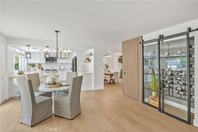 dining room featuring an inviting chandelier and light hardwood / wood-style floors