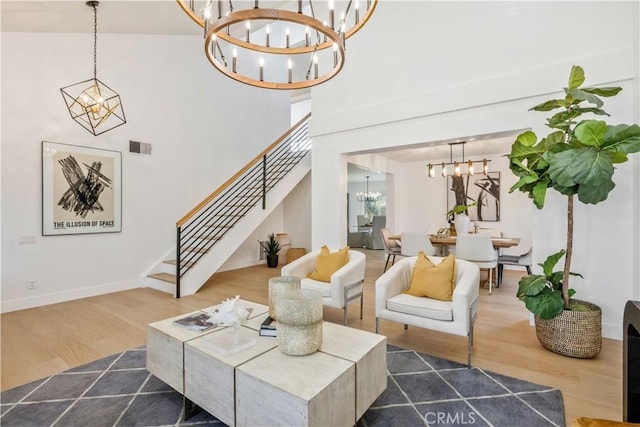 living room with dark hardwood / wood-style flooring, a high ceiling, and a notable chandelier