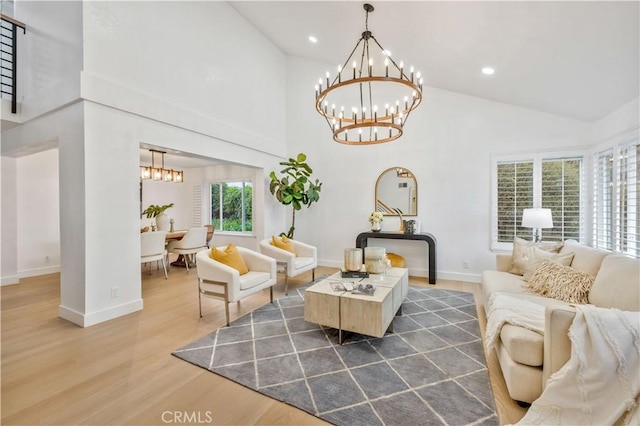 living area with high vaulted ceiling, recessed lighting, wood finished floors, and a notable chandelier