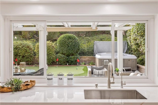 doorway to outside with plenty of natural light and sink