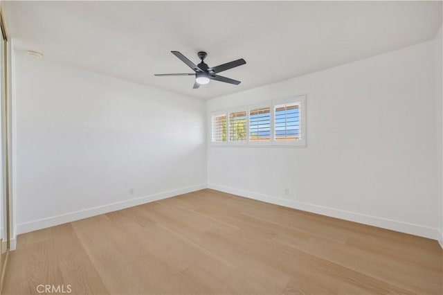 empty room featuring ceiling fan and light hardwood / wood-style flooring