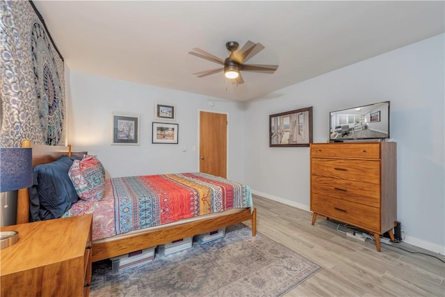 bedroom with ceiling fan and light hardwood / wood-style floors