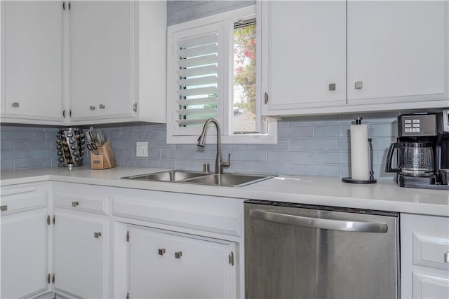 kitchen with white cabinetry, dishwasher, sink, and tasteful backsplash