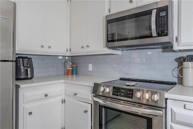 kitchen featuring white cabinetry, appliances with stainless steel finishes, and decorative backsplash