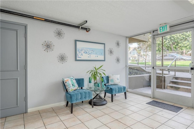 sitting room with light tile patterned floors and a textured ceiling