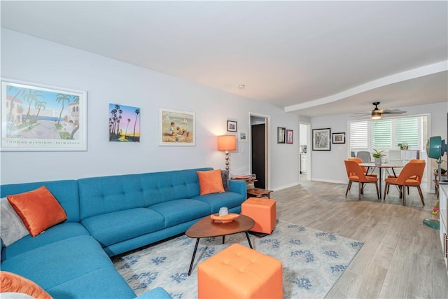 living room featuring light hardwood / wood-style floors and ceiling fan